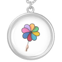 Kinderhand, die einen Pinwheel hält Amulett