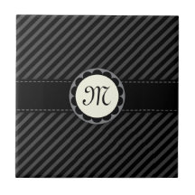 Schwarze und graue gestreifte Fliese des Monogramm