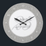 25th Wedding Anniversary Silver Stardust Confetti Große Wanduhr<br><div class="desc">25TH WEDDING ANNIVERSARY SILVER STARDUST CONFETTI CLOCK. Personalised with your names in faux silver over a beautiful script "25" (or a monogram initial),  on a delicate silver stardust confetti background. Designed by Pure Piglet© at www.zazzle.com/purepiglet*.</div>