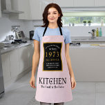 50th Birthday 1973 Name Elegant Black Gold Pink Schürze<br><div class="desc">A wonderful birthday black and gold design on an apron for that special celebration. Easily customize the text using the template provided. Part of the setting standards range of birthday supplies.</div>
