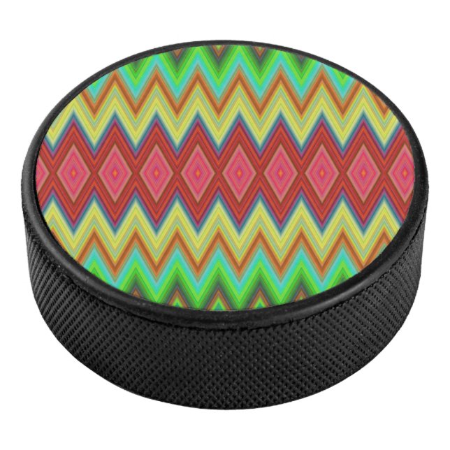 A circular speaker with a vibrant, zigzag pattern eishockey puck (3/4)