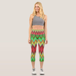 A person is wearing vibrant, geometric-patterned  capri leggings