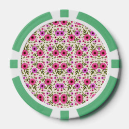 A poker chip with a floral pattern in pink 