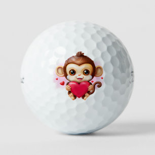 Adorable Baby Monkey hält ein rotes Herz Golfball