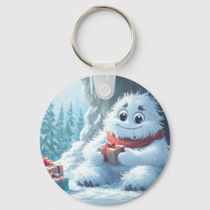 Adorable Yeti mit Weihnachtsgeschenken in einer Hö Schlüsselanhänger