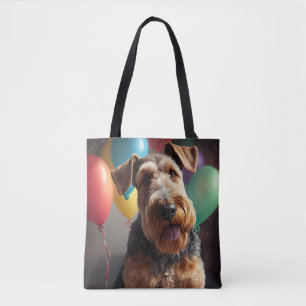 Airedale Hund mit Kuchen und Ballons