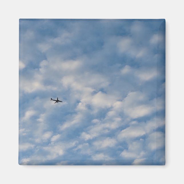 Airplane Crossing a Cloud-Filled Blue Sky Magnet (Vorne)