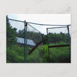 An abandoned house beyond the broken fence. postkarte