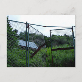An abandoned house beyond the broken fence. postkarte