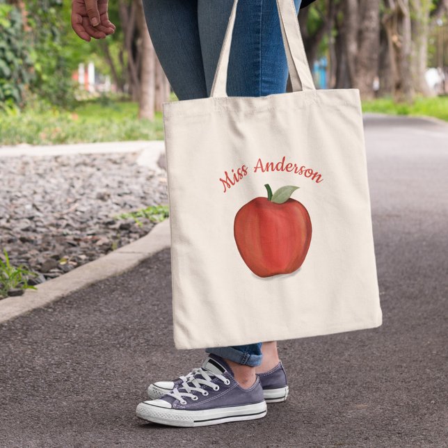 Apple-Schullehrer Tragetasche (Personalized teacher tote bag with red apple illustration and custom teacher name design.)