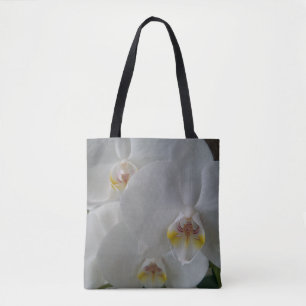 Atemberaubende weiße Orchideen auf einer Tasche mi
