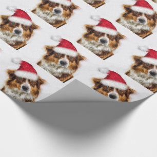 Australischer Schäferhund in einer Weihnachtsmannm Geschenkpapier