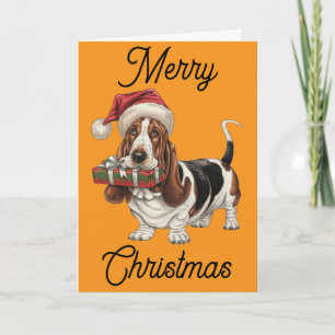 Basset Hound in Weihnachtsmannmütze im Mund Karte