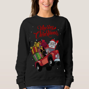 Belgische Malinois mit dem Weihnachtsmann im roten Sweatshirt