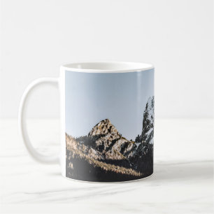 BERG MIT SCHNEEKAPPE WÄHREND DES TAGES KAFFEETASSE