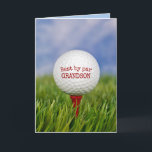 Birthday Golf Ball on T-Shirt - Grandson Karte<br><div class="desc">Nahe Aufführung des Golfballs auf rotem Tee in grünem Gras zum Geburtstag von Grandson. Alle Texte können bearbeitet werden.</div>