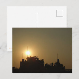 Black against the golden glow of the setting sun. postkarte