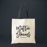Black Hand Letter Matron of Honour Tote Bag Tragetasche<br><div class="desc">Moderne und klassische Tasche mit schwarzer Schrift MATRON OF HONOR. Personalisieren Sie das,  indem Sie den Namen des Empfängers oder den Hashtag der Hochzeit hinzufügen. Ideal als Geschenk für Ihre Hochzeitsfeier oder Ihr Brautparty.</div>