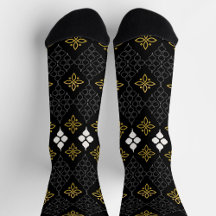 Black socks featuring a gold and white pattern 