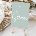 Blass Green Hand Scripted Tabelle SIEBEN Tischnummer<br><div class="desc">Einfache und schicke Tischnummer-Karten in Pale Sage Green und Weiß machen eine elegante Aussage bei Ihrer Hochzeit oder Veranstaltung. Das Design bietet "table [number]" in einem spannenden Mix aus klassischen Serifen und handgeschriebenen Skripten. Design wiederholt sich auf beiden Seiten. Einzelne nummerierte Karten werden separat verkauft; bestellen Sie jede Tischnummer einzeln...</div>