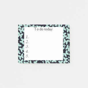 Blaue Schmetterlinge auf der schwarzen Post Notiz