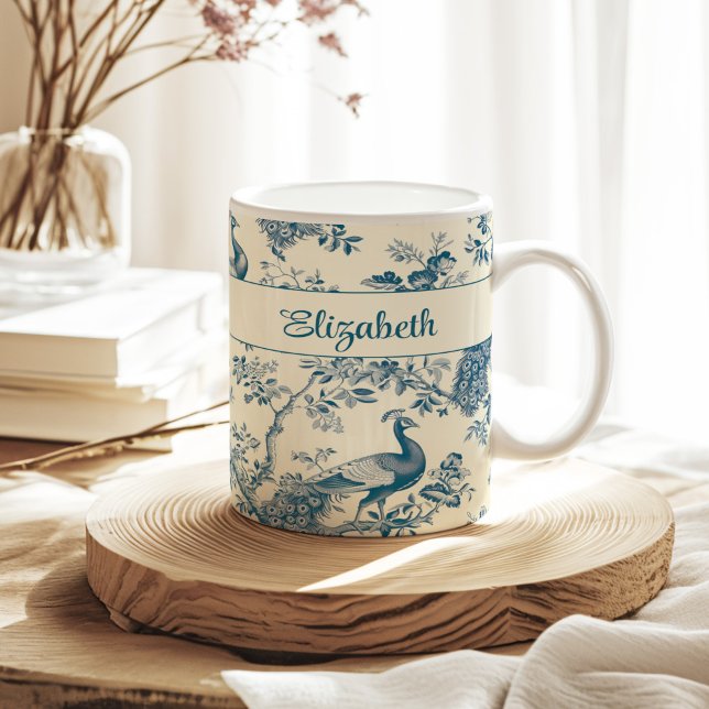 Blue Chinoiserie Peacock Individuelle Name Kaffeetasse (Blue Chinoiserie Peacock Custom Name Coffee Mug on a sunny neutral boho kitchen table.)