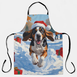 Bluetick Coonhound läuft im Schnee mit Weihnachten Schürze