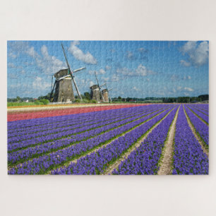 Blumen und Windmühlen in einer Frühlingslandschaft Puzzle