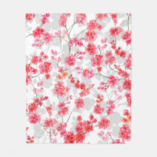 Branches of cherry blossoms on white and grey back fleecedecke