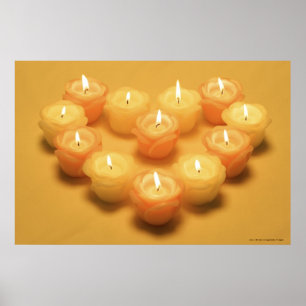 Burning candles arranged in a heart shape poster