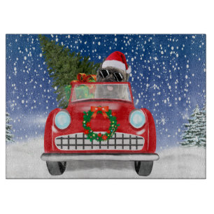 Cairn Terrier Hund fährt Auto im Schnee Weihnachte Schneidebrett
