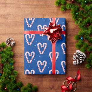 Candy Cane hört und schneebedeckt auf blau Geschenkpapier