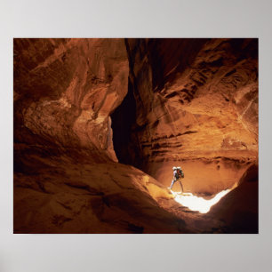 Canyoneer illuminated in the depths of a narrow poster