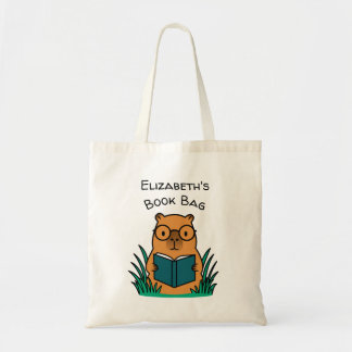 Capybara beim Lesen eines Buches Tragetasche