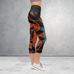 Cartoon Mandala Blume Blue Orange und Black Capri Leggings<br><div class="desc">Dieses trendige Mandala Blume Design ist in Blau,  Orange und Schwarz gehalten und im Cartoon-Stil gehalten. Trippige geometrische Visuals für den modernen Hippie oder Liebhaber lebendiger Farben!</div>