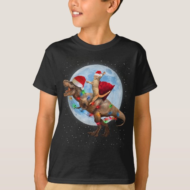 Cat Weihnachtsmannmütze Riding Dinosaur T rex Moon T-Shirt (Vorderseite)