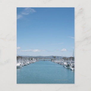 channel in harbor on a sunny day with blue sky postkarte