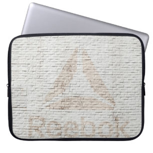 Close-up photo of Reebok logo on wall Laptopschutzhülle