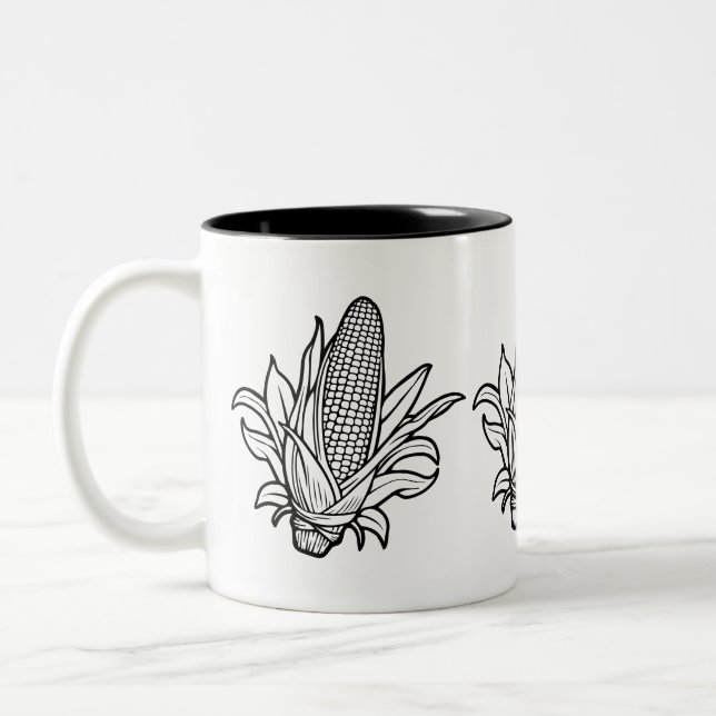 Cob-Ikone mit schwarz-weiß Mais und Blätter Zweifarbige Tasse (Links)