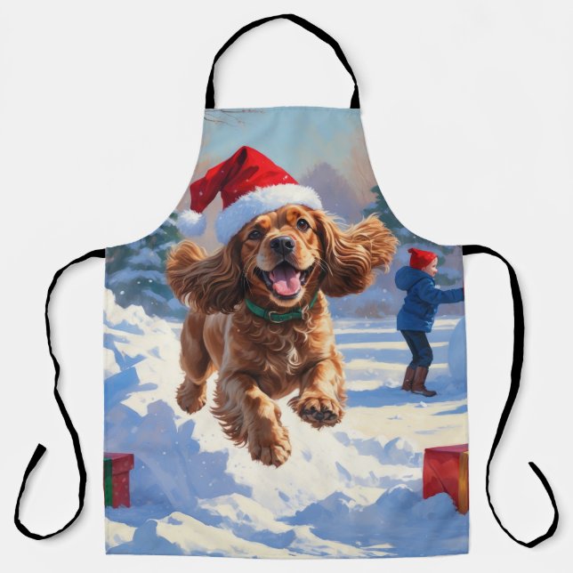 Cocker Spaniel läuft in Schnee mit Weihnachtshut Schürze (Vorderseite)