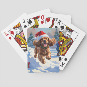 Cocker Spaniel läuft in Schnee mit Weihnachtshut Spielkarten