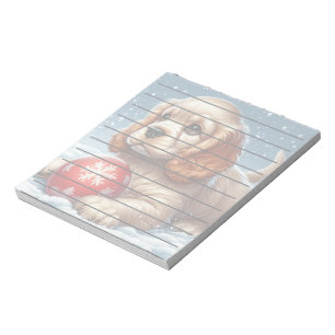 Cocker Spaniel Welpe auf Schnee mit einer Kugel Notizblock