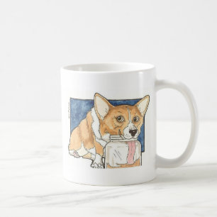 Corgi, der das Erdnussbutter-Glas leckt Tasse