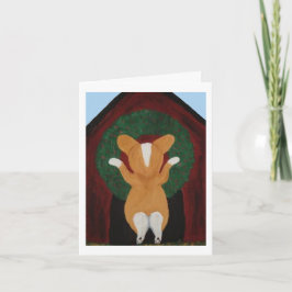 Corgi hängt Weihnachtskränze an das Hundehaus Karte