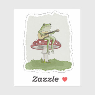 Cottagecore-Frosch spielt Gitarre auf Pilz-Kunst Aufkleber
