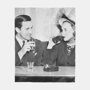 Couple sitting together in a restaurant flirting w fleecedecke