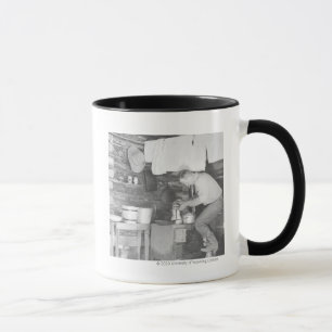 Cowboy, der im Bunkhouse Kaffee macht Tasse