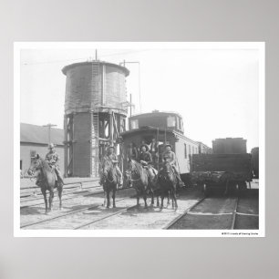 Cowboys auf den Pferden, die vor einem Zug Poster