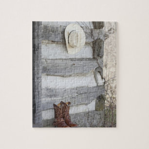 Cowboystiefel und Hut außerhalb des Blockhauses Puzzle