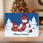 Crafty Snowman Knitting Scarf Feiertagskarte<br><div class="desc">Vector Illustration von zwei bezaubernden Schneemännern aus Strickhütten und Schals aus Cartoon. Der große,  beschissene Schneemann strickt einen übergroßen Schal für den Kleinen. Der Schal ist schon mehrmals um den niedlichen kleinen Schneemann gewickelt.</div>